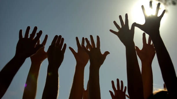 istock People raising hands, voting for democracy, volunteering campaign, leadership 1131888923