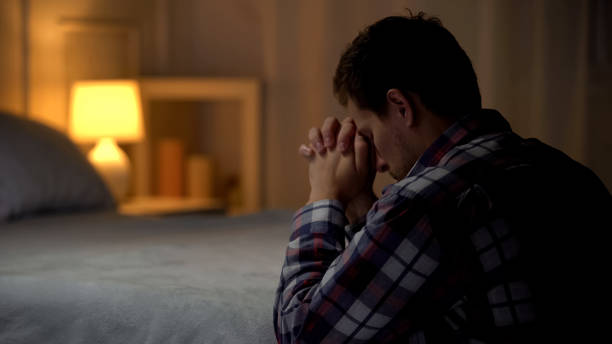 religious-young-man-praying-in-evening-n