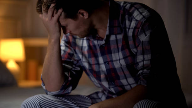 istock Sad man crying, sitting on bed, relative loss, lack of support, grief and sorrow 1131889263