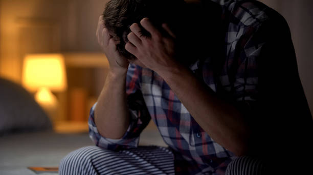 istock Hopeless lonely man sitting on bed, suffering depression, life difficulties 1131889265