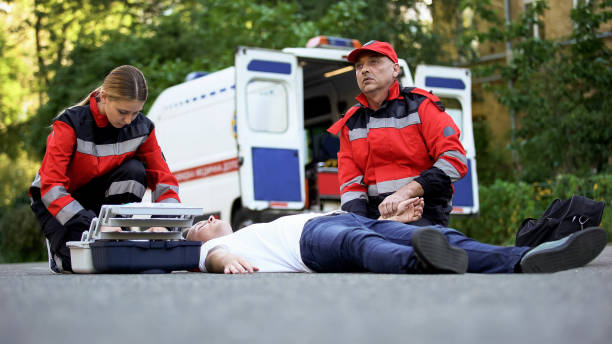 istock Doctor checking pulse of man lying on road, heart problems, low sugar blood 1131889363