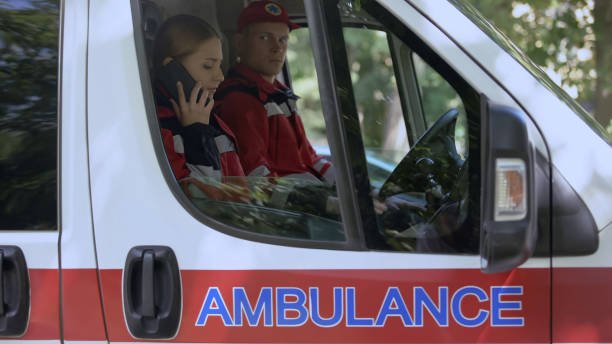 istock Female paramedic using smartphone to call patient, ambulance crew on-duty 1131889372