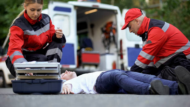istock Medics helping man on road, preparing insulin to unconscious diabetic, first aid 1131889393