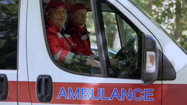 istock Male doctors in ambulance looking at camera, professional emergency service 1131889405