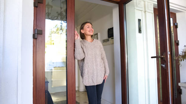 istock Beautiful woman standing by house and smiling, waiting for husband from work 1131890166
