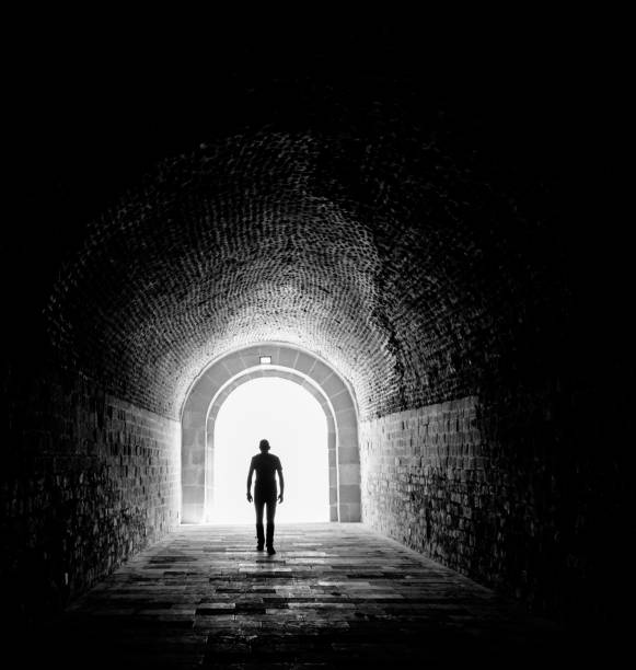 istock man at Dark room with light painting background 1131890470