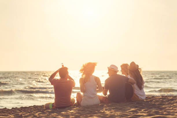 istock Group of friends on the beach enjoy 1131890775