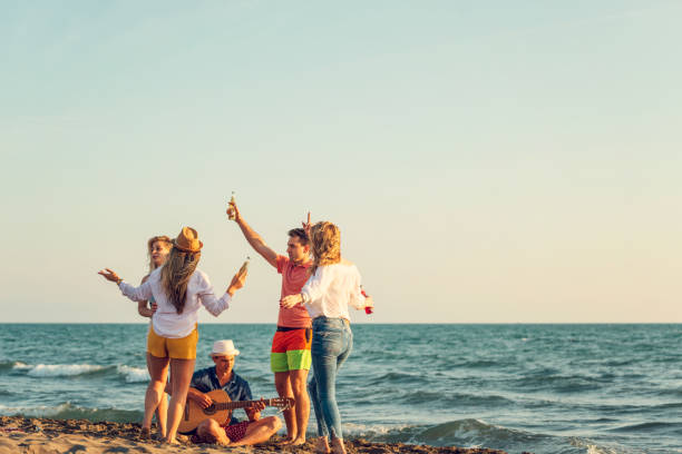 istock Group of friends on the beach enjoy 1131890921