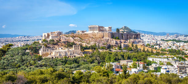 Panorama of Athens with Acropolis hill, Greece Panorama of Athens with Acropolis hill, Greece. Famous old Acropolis is a top landmark of Athens. Ancient Greek ruins in the Athens center in summer. Scenic view of remains of antique Athens city. parthenon athens photos stock pictures, royalty-free photos & images