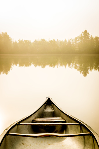 Fisherman in Tuyen Lam lake in a foggy morning, Da Lat city, Lam Dong province, central high lands Vietnam