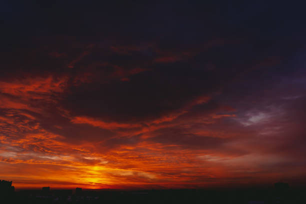 istock Fiery red blood vampire dawn. Amazing warm dramatic fire blue dark cloudy sky. Orange sunlight. Atmospheric background of sunrise in overcast weather. Hard cloudiness. Storm clouds warning. Copy space 1131897889