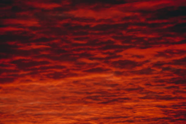 istock Fiery red blood vampire dawn. Amazing warm dramatic fire cloudy sky. Vivid orange sunlight. Atmospheric background of sunrise in overcast weather. Hard cloudiness. Storm clouds warning. Copy space. 1131897893