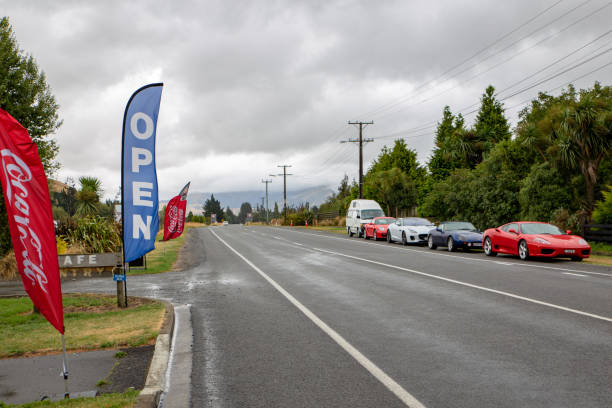 luxury cars parked outside a rural cafe in new zealand - photography starbucks flag sign imagens e fotografias de stock