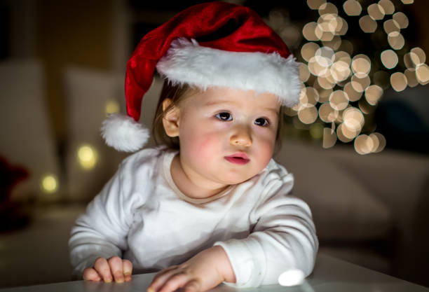 Toddler boy playing with a Santa hat around Christmas time
