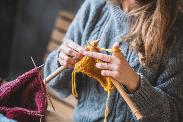 istock Close up on woman's hands knitting 1131900884