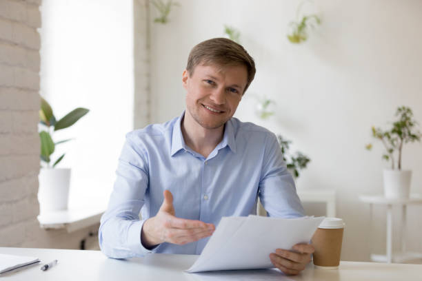 istock Headshot portrait successful businessman holds documents smiling looking at camera 1131900952