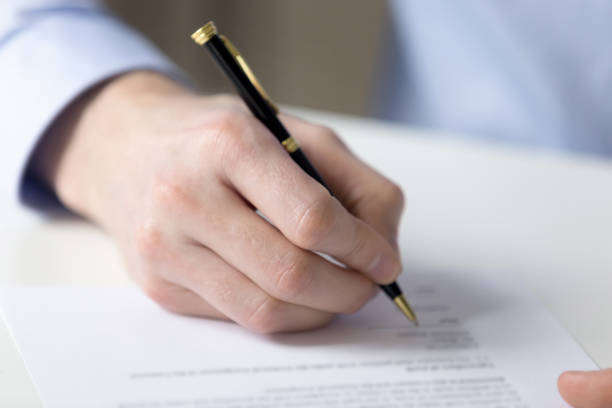 istock Close up male hand fill contract paper 1131900956
