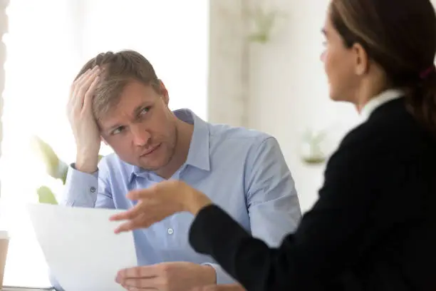 Photo of Confused hr manager and female applicant negotiating