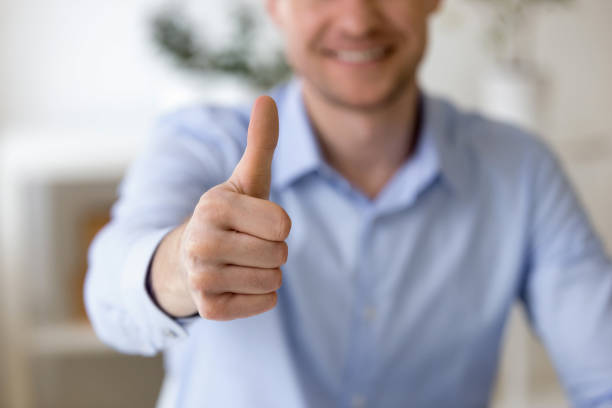istock Close up businessman smiling showing thumbs up 1131900973