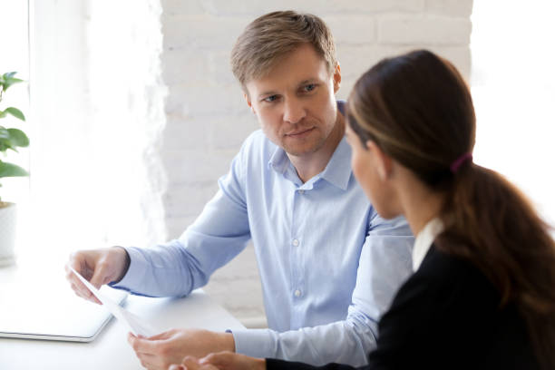 istock Hr manager and applicant sitting at desk during job interview 1131900976