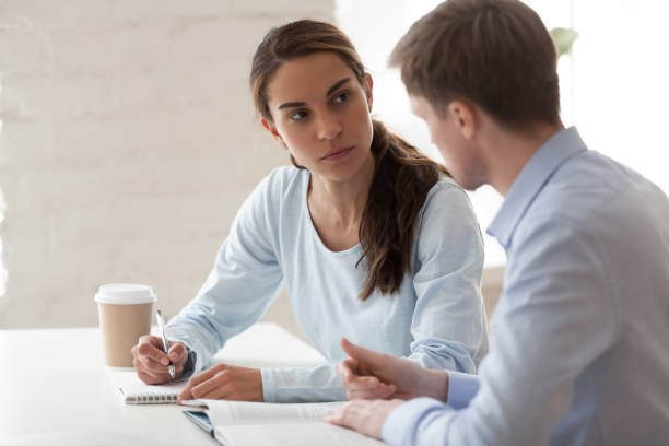 istock Mixed race and caucasian colleagues studying working together 1131900981