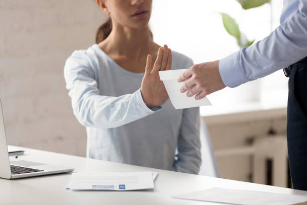 Woman refusing money in the envelope offered by man