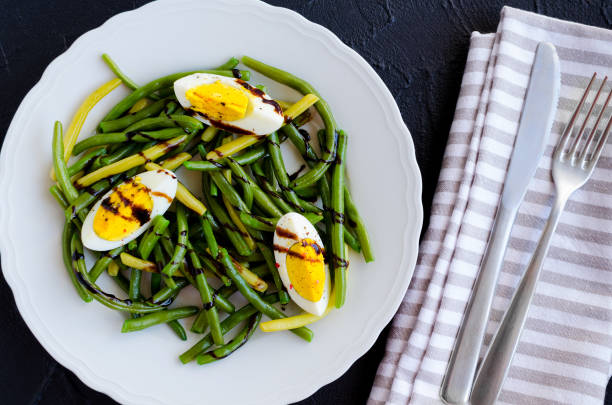 istock Warm salad with cooked green beans and boiled eggs 1131902389