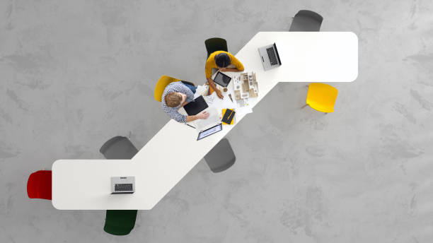 Architects at work Overhead view of two architects working on a project in the office architectural model photos stock pictures, royalty-free photos & images
