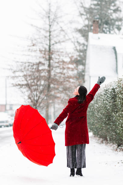 istock Woman in red dancing in the snow 1131904784