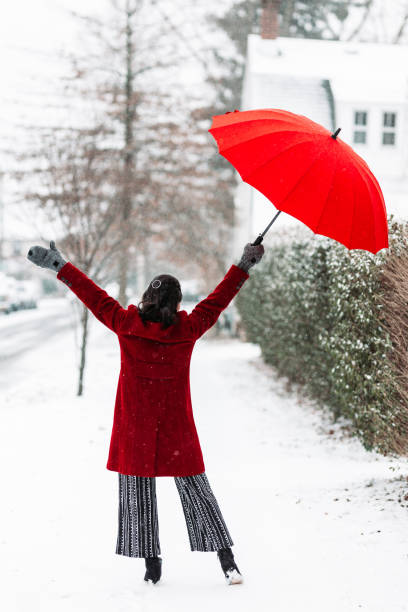 istock Woman in red dancing in the snow 1131904792