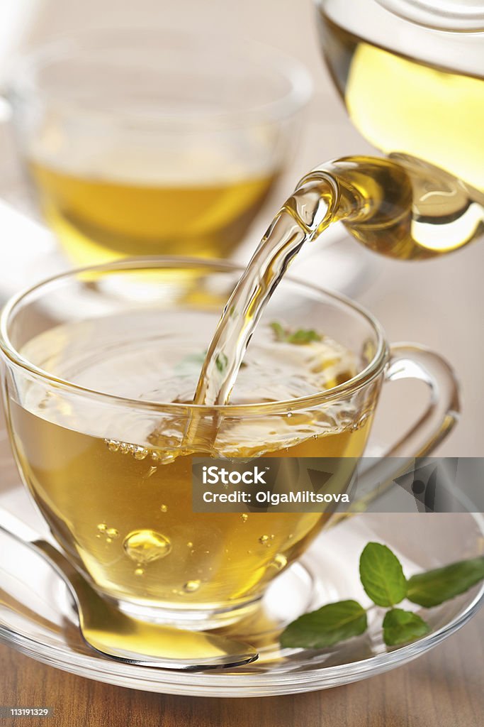 green tea pouring into glass cup  Antioxidant Stock Photo
