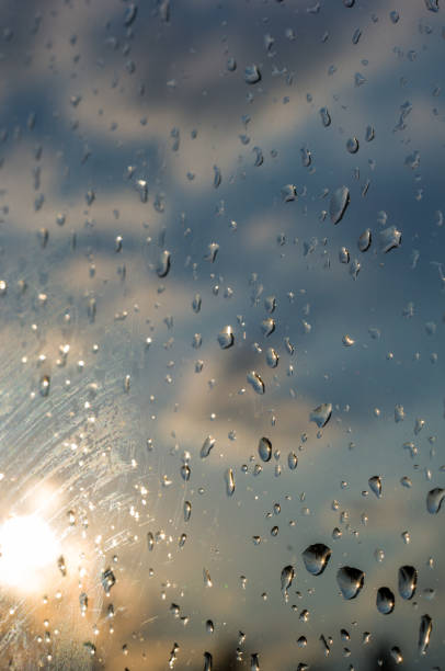 istock raindrops on window glass on background of cloudy sky 1131914729