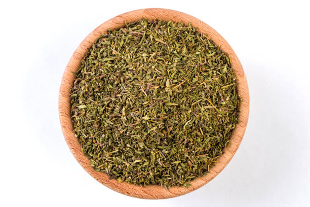 istock thyme herb in wooden bowl isolated on white background. 1131918321
