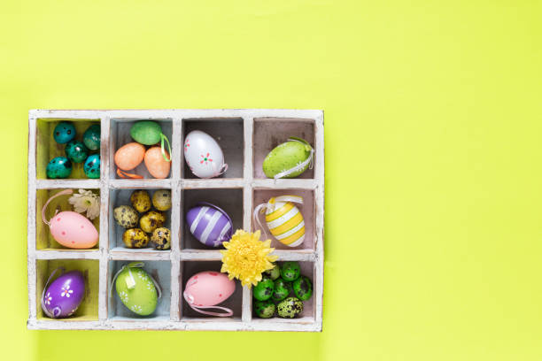 istock Colourful Easter Eggs in a Wooden Box on bright  green background, top view - Image 1131919104