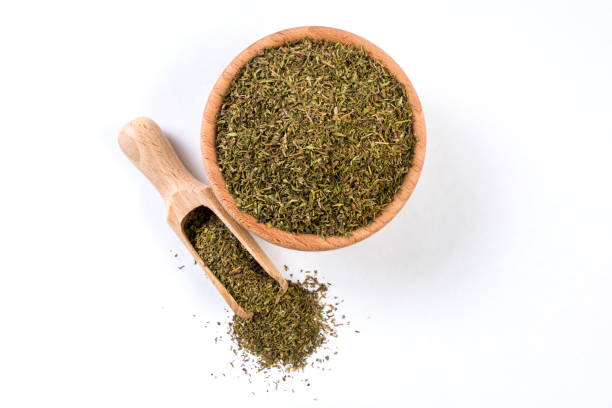istock thyme herb in wooden bowl and scoop isolated on white background 1131919353