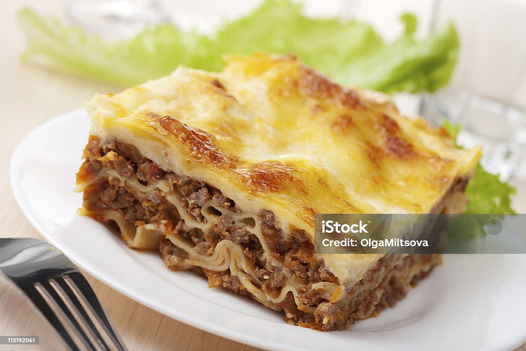 Slice of lasagna Bolognese with fresh greens bolognese lasagna Lasagna Stock Photo