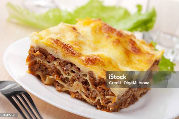 Slice Of Lasagna Bolognese With Fresh Greens Stock Photo - Download Image Now - Lasagna, Slice of Food, Baking