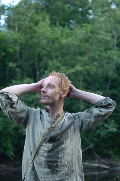 istock young man in wet military uniform during world war II in the forest 1131922449