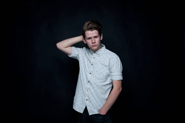 istock Young handsome man standing in front of black background 1131931522