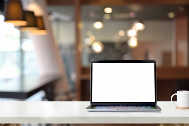 istock Mockup blank screen laptop on white desk table in office 1131932024