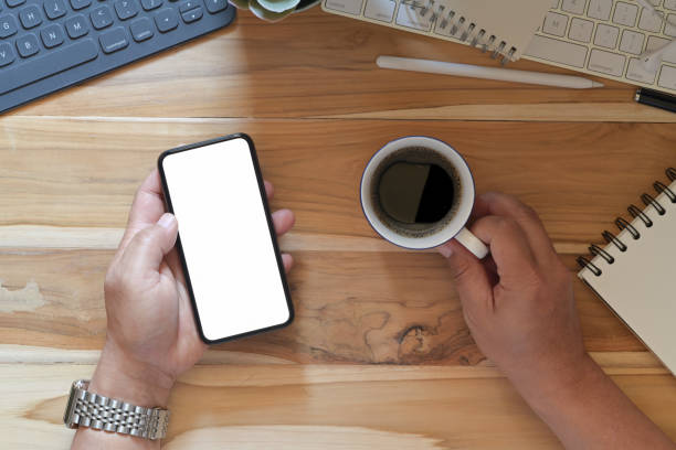 istock Male hands using smartphone blank screen mockup at the office desk 1131933304