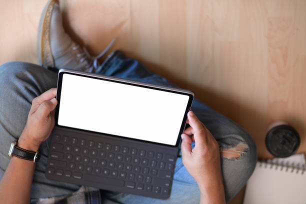 istock Young man sitting on floor with working on tablet 1131933501