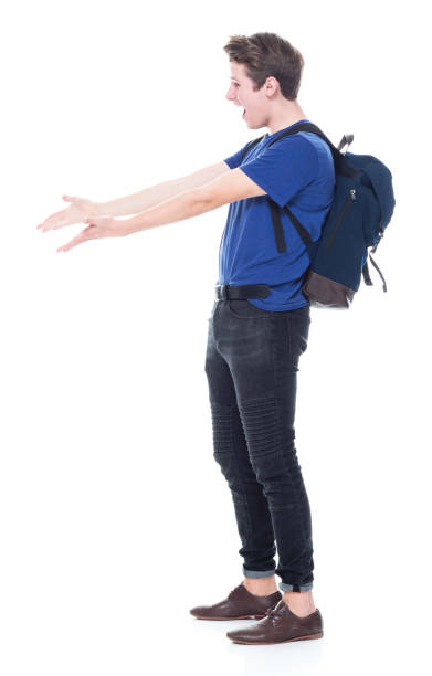 istock Young high school age male student is showing to the side 1131933679