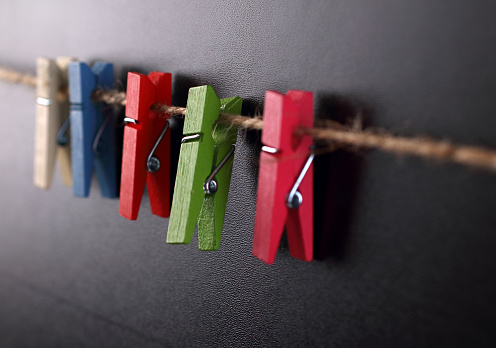 Colorful clothespins on rope