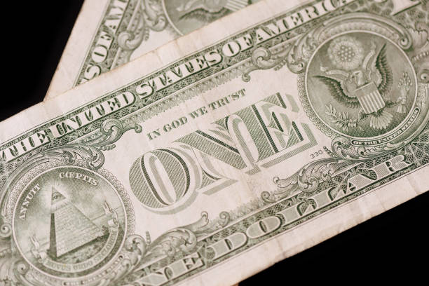 istock American dollars on a dark background. Brown color toned 1131940932