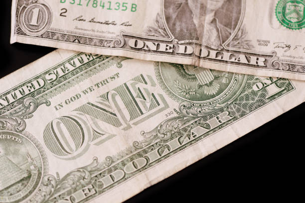istock American dollars on a dark background. Brown color toned 1131940943