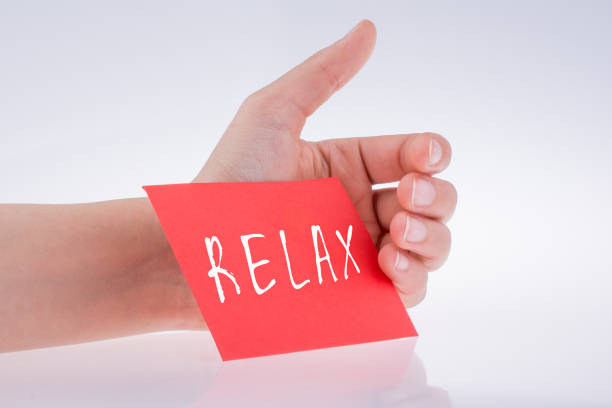 istock Relax wording written on paper in hand 1131941786