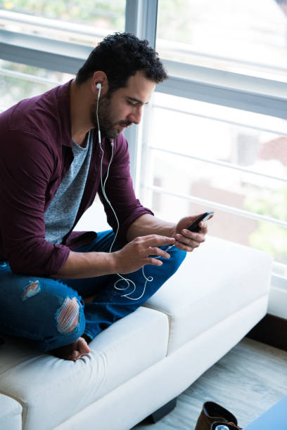 istock Concentrated man listening to a podcast 1131942160