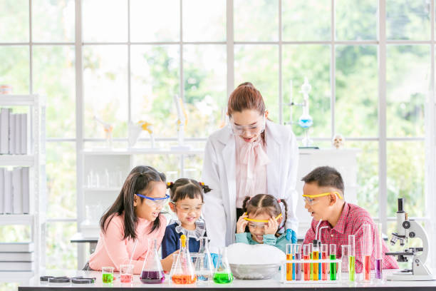istock Teacher and students in lab, smoke float out. 1131942969