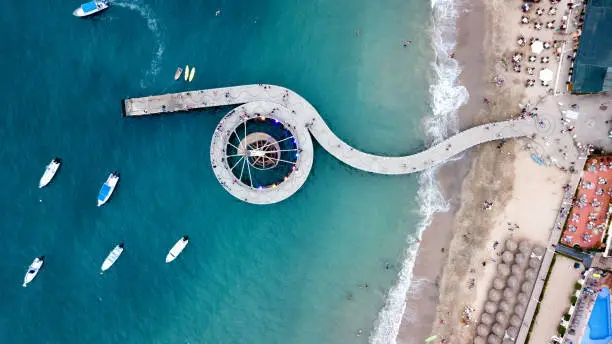 A Drone shot of Banderas Bay, the beach, El Malecon Los Muertos Pier and cityscape of Puerto Vallarta